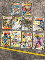 All ten Micronauts comics issues 1-10 laid out on grey carpet