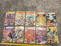 Front covers of Micronauts: The New Voyages issues 1-10 laid out on floor with ruler for scale