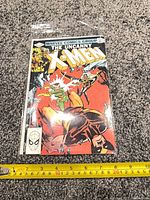 Front cover of The Uncanny X-Men #158 comic book with measuring tape for scale