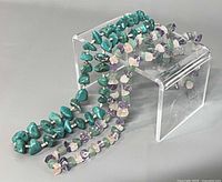 Both gemstone necklaces displayed together, turquoise necklace and fluorite necklace