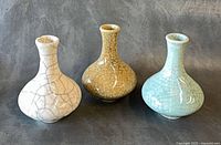 Front view showing three vases and crackle glaze colors