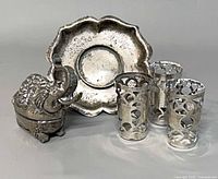 Group shot of elephant box, scalloped dish, three shot covers