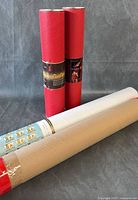 Four rolled stamp sheets in two red and two kraft tubes