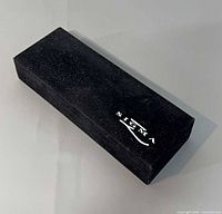 Closed black velvet Sigma branded case