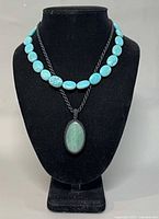 Both necklaces displayed on bust form