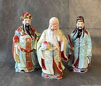 Front view of three hand-painted Fu Lu Shou ceramic figurines