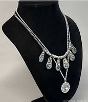 Both necklaces displayed on bust, side angle