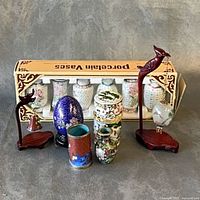 All items grouped: box of vases, cloisonné pieces, eggs, stands, trinket box
