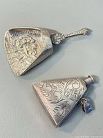 Both silver items side by side, showing overall shapes and engravings