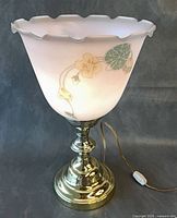 Full view of table lamp showing brass base and pink hand-painted glass shade