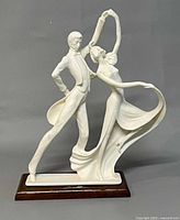Front view of Santini dancing couple sculpture on wood base