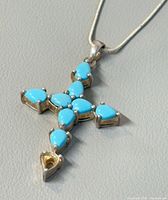 Close-up of pendant front, turquoise stones and missing bottom stone
