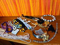 All necklaces laid out on wooden surface