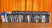 Full row of PlayStation game cases showing spine titles and formats
