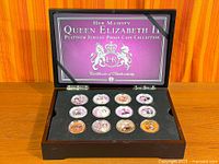 Open presentation case showing 12 of the encapsulated coins plus case interior