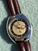 Close-up of Ricoh Crystal watch dial showing brand, 21 jewel marking, day-date window