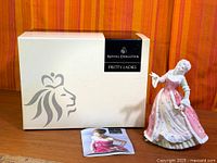 Figurine, original box and leaflet displayed together