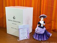Figurine, box, certificate displayed together