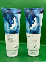 Front view of two identical Voir hair masque tubes