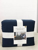 Front of packaged dark navy Threshold washed cotton sateen king duvet cover set showing label