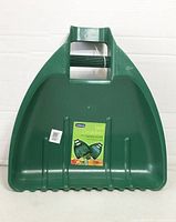 Front view of leaf grabber showing interior scoop surface, serrated edge and brand label