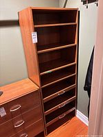 Full view of laminate shelf unit showing shelves and pull-out trays