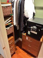 Shelf tower with drawers and baskets next to dresser