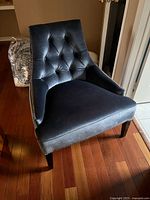 Front view of tufted velvet accent chair showing overall design