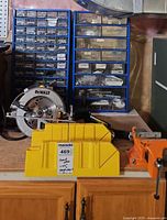 Circular saw, vise, miter box, two blue organizers with hardware drawers
