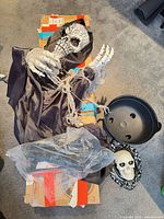 Hanging skeleton prop, skull mirror, plastic cauldron, boxed tree and cloth