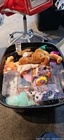 Bin with assorted plush and display cases
