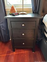 Front view of one nightstand showing color, drawer arrangement, knob style