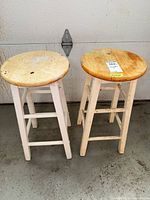 Two wooden stools side by side showing overall look and wear