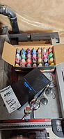 Box of roughly 30 assorted paint bottles plus black box and airbrush components