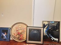 All four framed prints lined up on floor