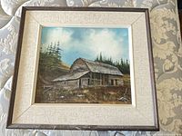 Full view of framed painting showing cabin, mats and frame