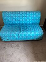 Loveseat in sofa position with blue patterned cover