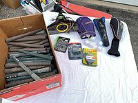 Box of spiral-textured rubber grips, assorted accessories laid out