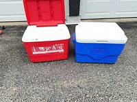 Front view of both coolers, red lid open, blue closed