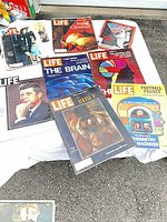 All eight magazines spread out on table showing front covers