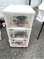 Full view of 3-drawer plastic storage unit showing contents