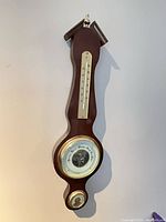 Full view of wall-mounted mahogany banjo weather station