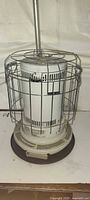 Full view of kerosene heater showing body, guard and base