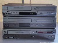 Front view of stacked Sylvania, Philips and Magnavox players
