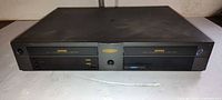 Front view showing dual VHS decks, model label DDV9500