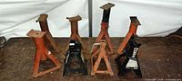 Six jack stands grouped on workbench