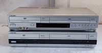 Two stacked Sony DVD/VHS combo units front view
