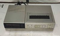 Front and top view of RCA Betamax VCR showing transport controls and cassette bay