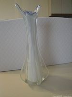 Full view of tall clear and white opalescent glass vase