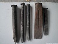 Front view of five steel chisels showing varied tip shapes